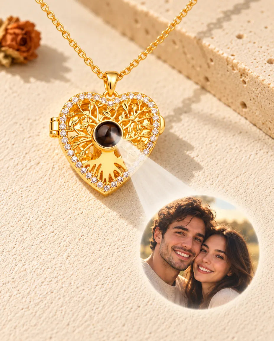 Light shining through the brown stone of the gold tone heart locket projects a photo of a smiling couple