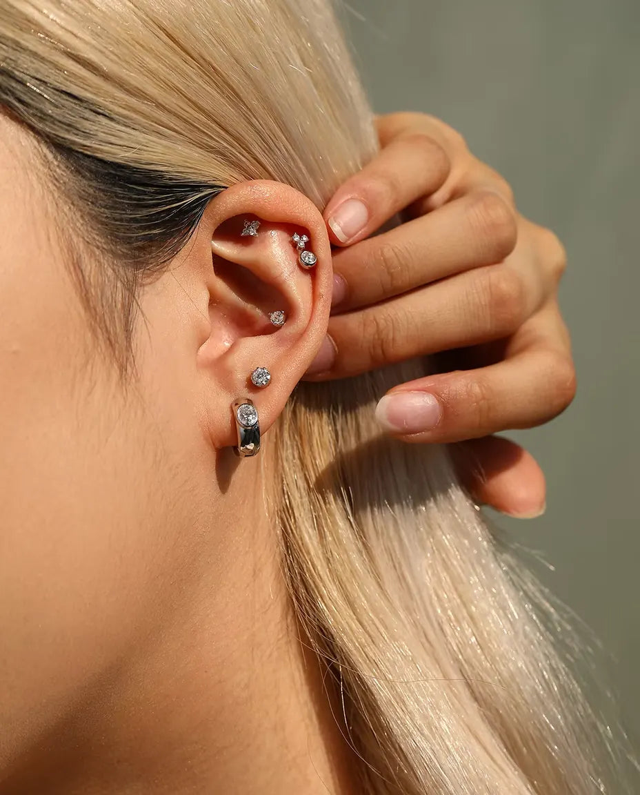 Round Moissanite Stud Earrings in 925 Sterling Silver - worn on a model tucking her hair behind her ear
