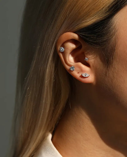 Round Moissanite Four-Prong Stud Earrings in 925 Sterling Silver - worn together with other studs in the same ear