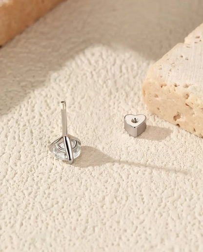 Round Moissanite Three-Prong Stud Earrings in 925 Sterling Silver - with the heart-shaped back taken off and set beside it
